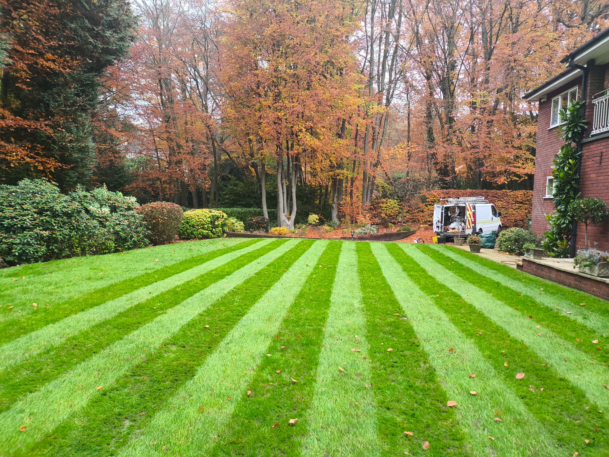 Autumn striped lawn with work van